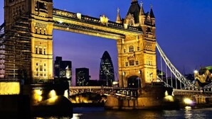 A large, historic bridge with intricate architecture and a city skyline in the background. - Ideally located cosy flat (London)