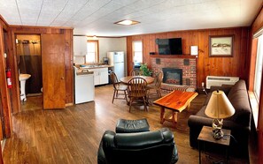 Deluxe Cabin | Living area | 50-inch Smart TV with digital channels, fireplace