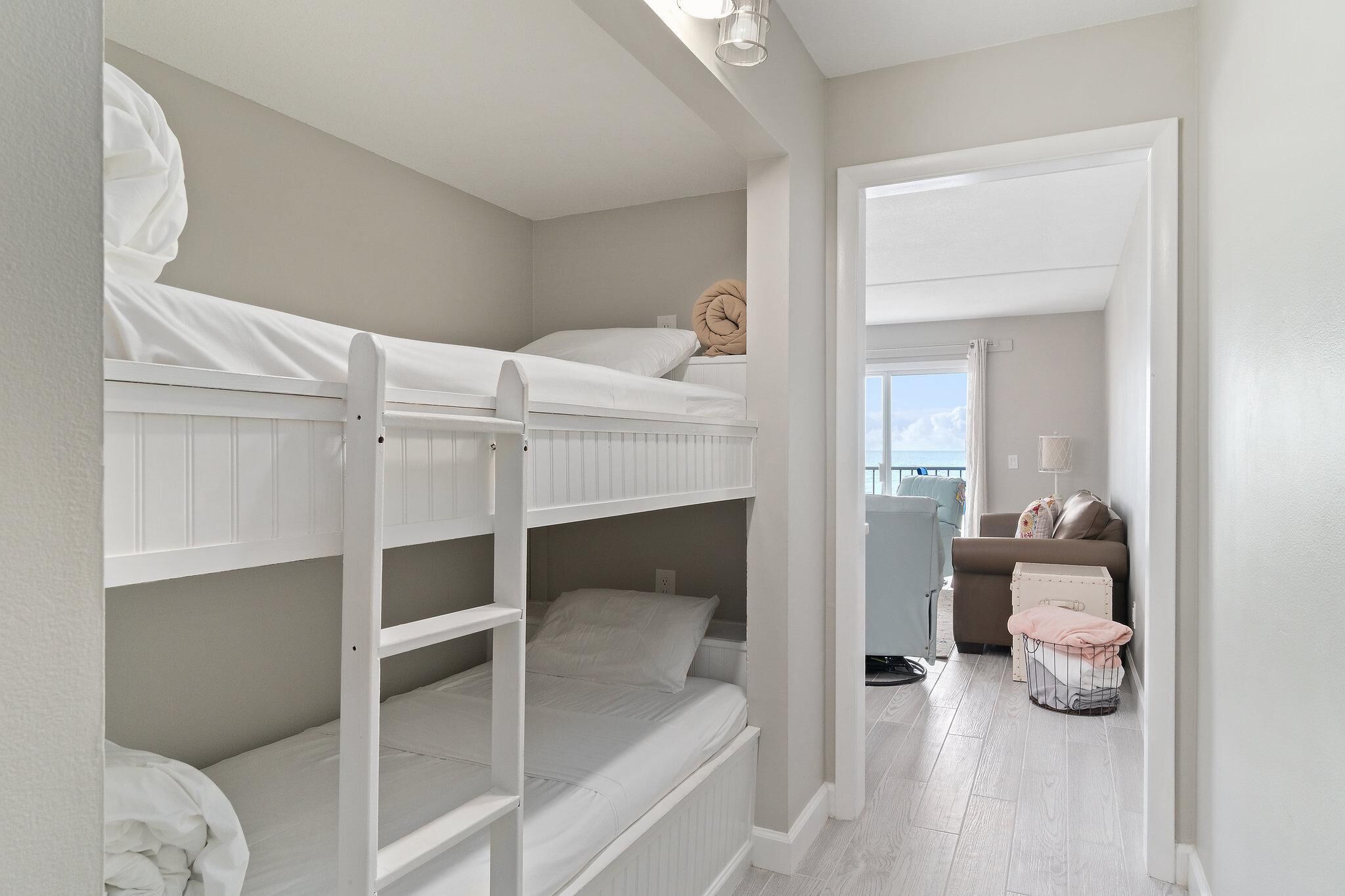A bunk bed room with a view to the outside.