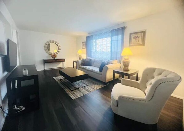 Relax in this stylish living room with a sofa, armchair, and coffee table.