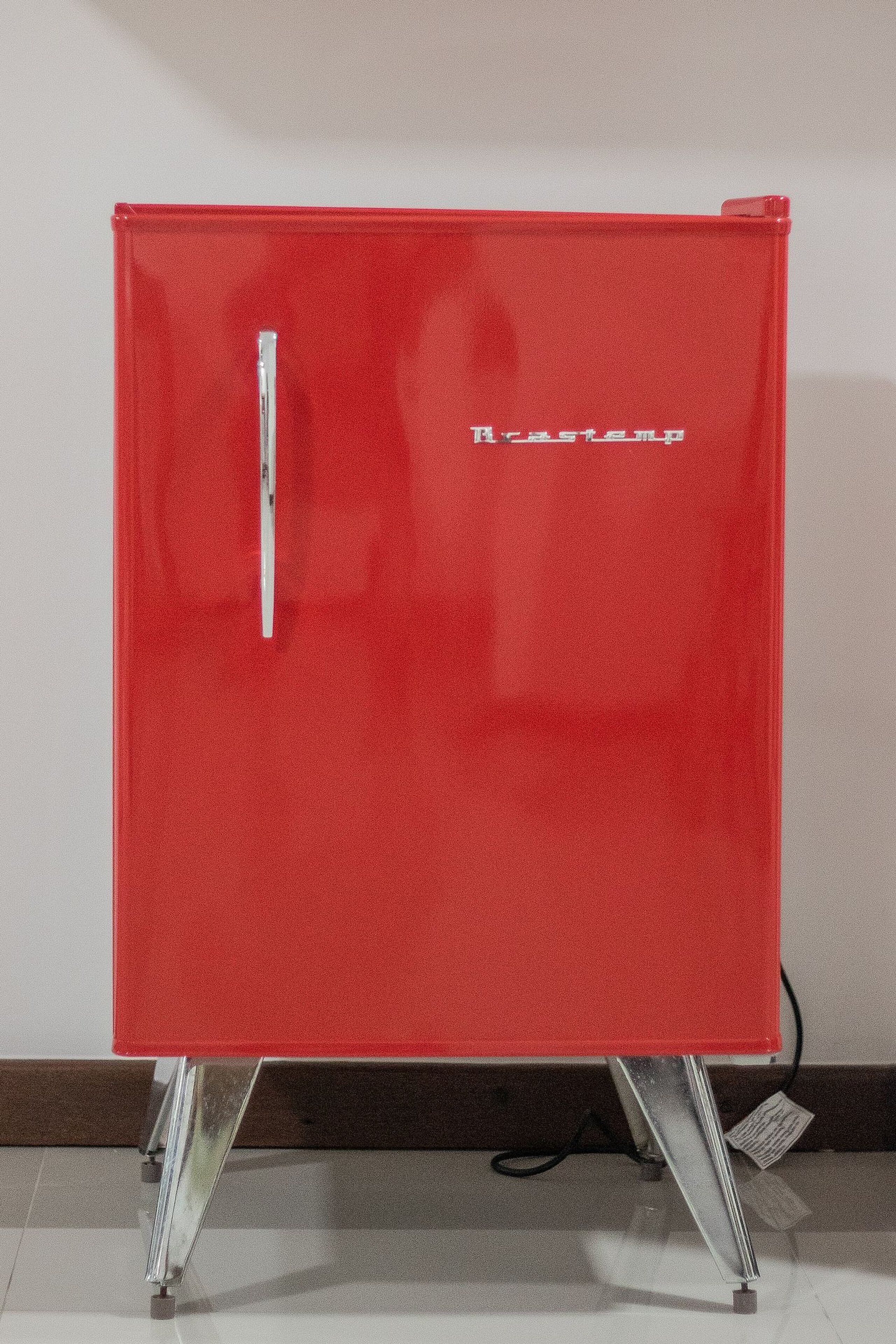 A red cabinet with a handle and the brand name "Rastemp" on the front.