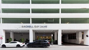 A building with a sign reading "BROCKELL BAY DRIVE" and two cars parked in front. - One of Brickell Bay's Best w/ Pool and Gym Access (Miami)