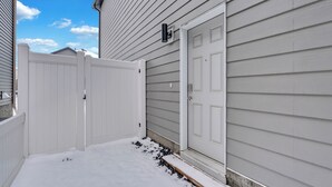 A snow-covered front porch with a white door and a mailbox. - Beautiful Modern Unique Suite (Calgary)