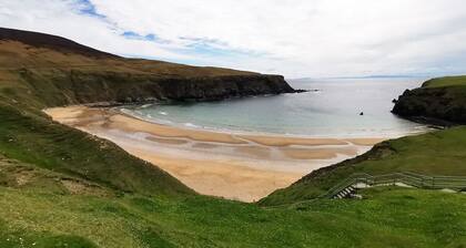 Teach Condy's Cottage nestled at the bottom of Sliabh Liag Cliffs, Co. Donegal