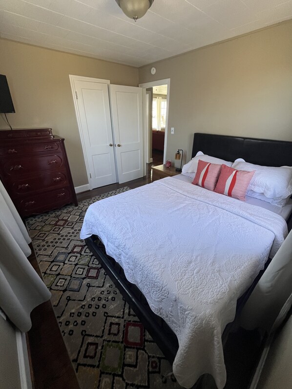 A bedroom with a large bed, a dresser, and a wardrobe. - 🥤The Coca Cola House 🥤 (Roanoke)
