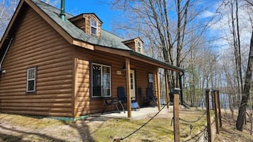 Relax on the porch with a view of the surrounding woods.