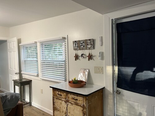 Step into this cozy 2-bedroom cabin nestled in the tranquil woods. The main living area offers comfy seating, including a pull-out futon for additional sleeping space. An efficiency kitchen awaits your culinary adventures, equipped with essentials fo