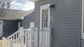 A house with a white front porch and a window with a white frame. - Harbor Heights  (Greenport)