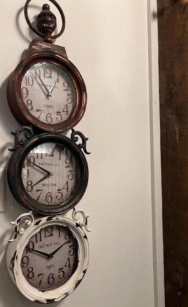 A wall-mounted clock with three different time zones displayed. - Livery Loft: our other BEST downtown location! Award winning! Come see why. (Madison)