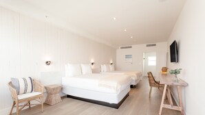 A spacious bedroom with a large bed, a bedside table, a chair, and a wooden desk. - Casa SOBE (Miami Beach)