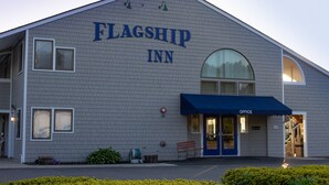 A building with a sign reading "FLAGSHIP INN" and a blue awning labeled "OFFICE".