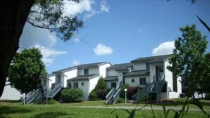 A row of modern, two-story residential buildings with multiple staircases leading to the entrance. - Endless Mountain Resort (Union Dale)