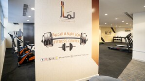 A fitness center with exercise equipment, including treadmills and elliptical machines. - Lamar Ajyad First Hotel Tower B (Makkah)