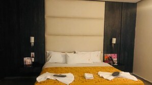 A hotel room with a large bed, two bedside tables, and a headboard. - HOTEL M DORADO (Mexico City)