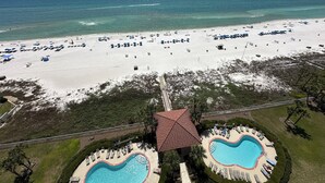 A beach resort with a large sandy beach, a swimming pool, and a view of the ocean. - 1303 is a beautiful 2br/2ba 13th floor unit with a magnificent view! (Panama City Beach)