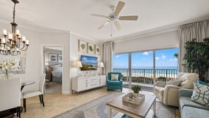 A spacious living room with a balcony overlooking the beach, a dining area, and a kitchen. - 2nd fl. 2 br newly remodeled unit with Stunning Views! Beach chairs included! (Panama City Beach)