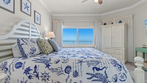 A bedroom with a large bed, a ceiling fan, a view of the ocean, and a white wardrobe. - Coral Reef, Unit #1102 (Beachfront 2 bedroom 2 bath condo on the 11th floor) (Panama City Beach)