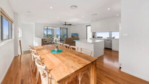 A modern kitchen with white cabinets, a central island, and a dishwasher. - Pearls on Sapphire Beach (Sapphire Beach)