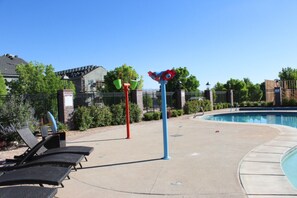 A pool area with lounge chairs, a pool, and a decorative pole. - Brand New Home! Roof Top Deck, Games for everyone, Private Pool (Hurricane)