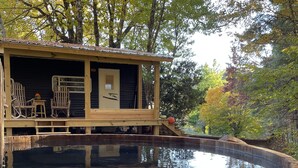 A wooden deck with outdoor seating and a swimming pool. - LINVILLE Nostalgic Mountain Farm Glamping Camper on Wedding Venue, 10 acre farm  (Linville)