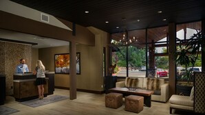 A reception area with a reception desk, a sofa, and a coffee table. - Connect with Nature | 1 King + ADA rated (Bend)