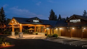 A lodge with a 'Currents' and 'Riverhouse' sign, outdoor seating, and a parking area. - Luxury in Bend, OR | Bunk Bed Room close to Nature (Bend)