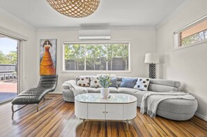 Family House, Garden View | Living area | 55-inch TV with cable channels - StayAU 4BRM Chic Urban Retreat (Officer)