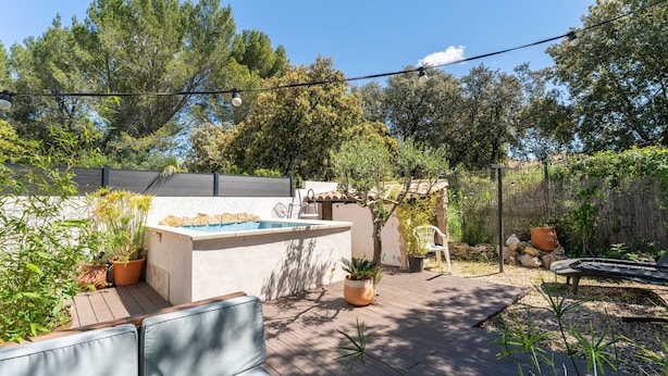 A backyard with a pool, outdoor seating, and potted plants. - Holiday Home 'Loft Des Cigales' with Private Pool and Private Terrace (Uchaud)