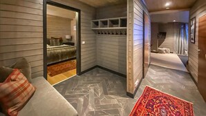 A modern interior with a seating area, a hallway with a patterned floor, and a room with a bed and a window. - Amazing apartment in Noresund with WiFi (Noresund)