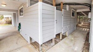 A house with a concrete foundation, wooden posts, and a white exterior. - Oceanside, Hot Tub, Rec Room, OD1, The Sandy Dune (Duck)