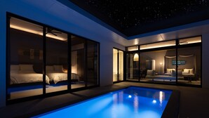 A modern hotel room with a pool, large glass windows, and a ceiling with a starry design. - CLASS THE FIRST (Miyakojima)