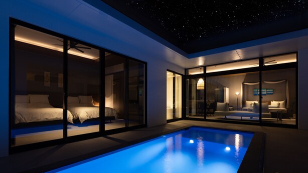 A modern hotel room with a pool, large glass windows, and a ceiling with a starry design. - CLASS THE FIRST (Miyakojima)