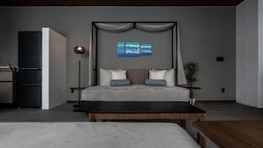 A modern bedroom with a bed, bedside tables, a floor lamp, and a large window. - CLASS THE FIRST (Miyakojima)