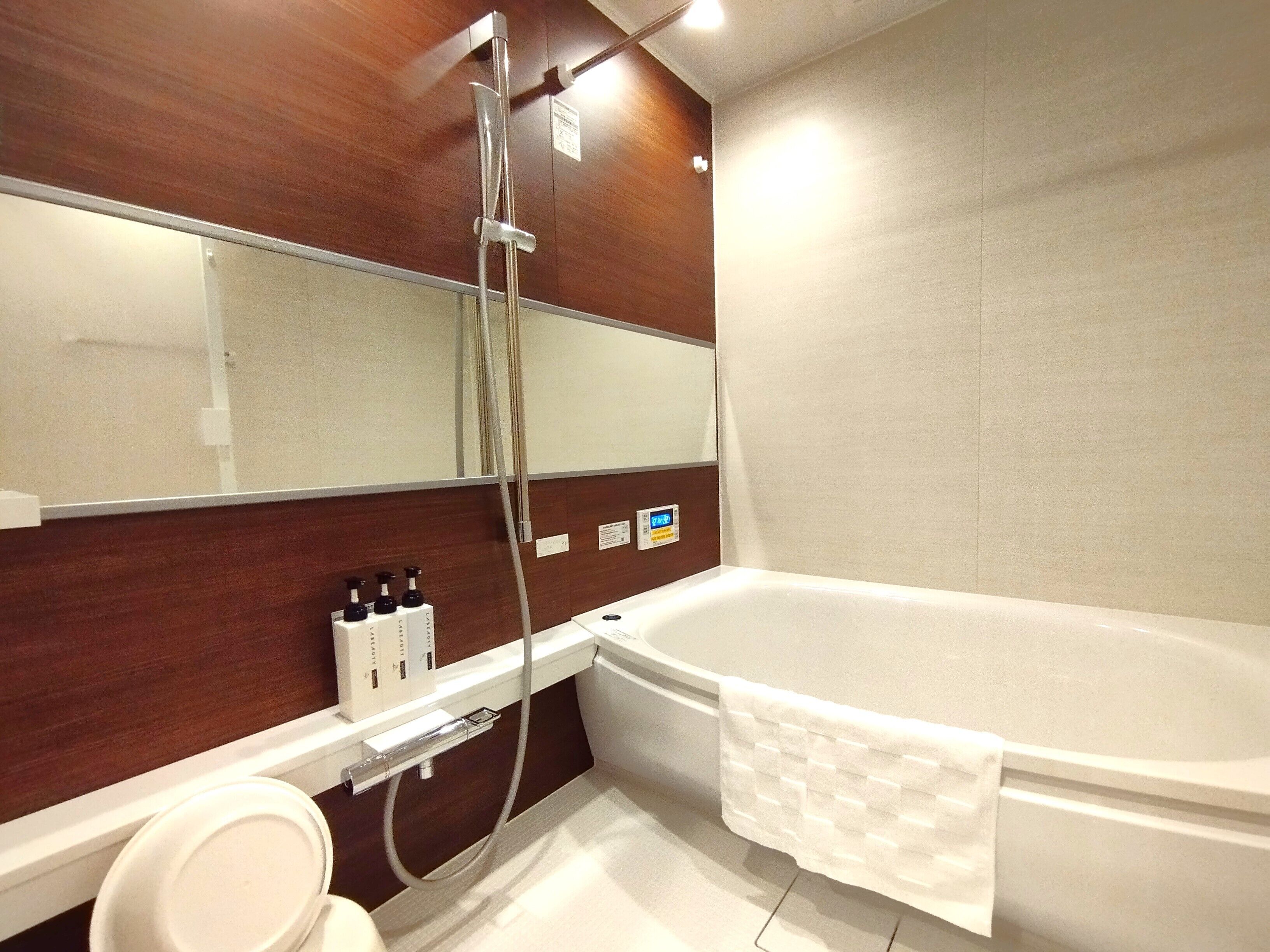 Separate bathtub and shower, free toiletries, hair dryer, slippers