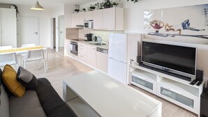 A modern apartment with a living room, kitchen, and dining area. - Cozy Apartment with Big Terrace - Karlín (Prague)