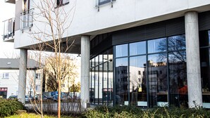 A modern building with large windows and a minimalist design.