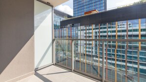 A modern building with large windows and a balcony. - Burakowska Pastel Elegant Apartment (Warszawa)