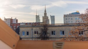 A cityscape with a prominent historic building and a modern skyscraper.
