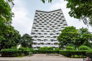 En høj bygning med et unikt arkitektonisk design og flere altaner.