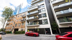 A modern building with multiple floors, large windows, and balconies. - Złota Sophisticated Apartment (Warszawa)