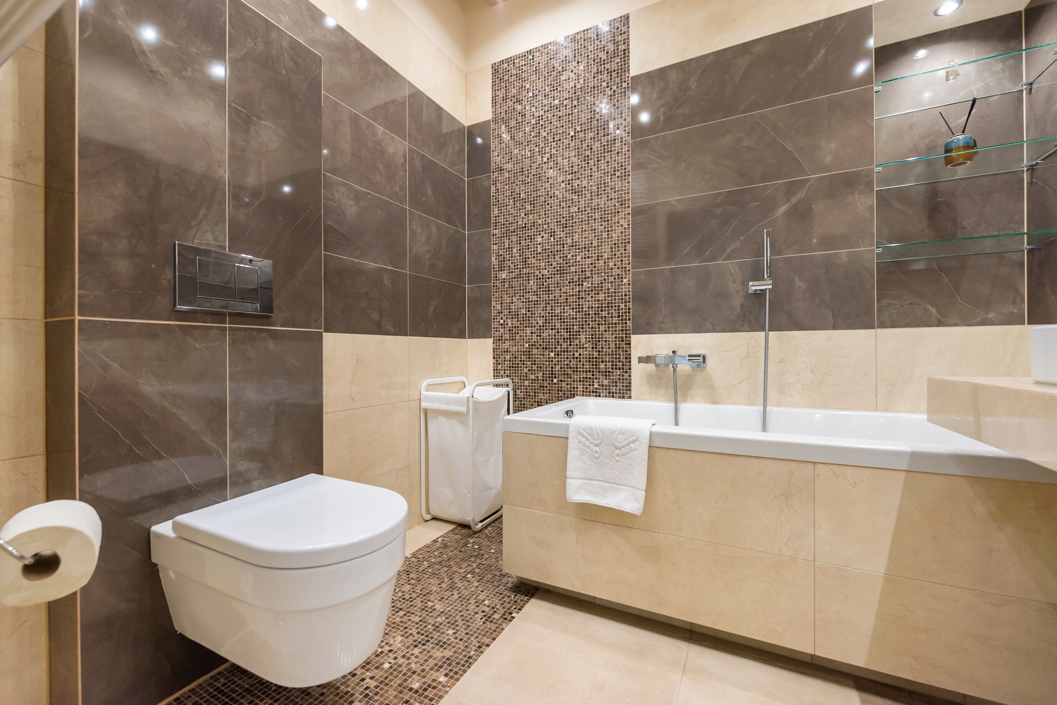 A modern bathroom with a toilet, sink, and shower area.