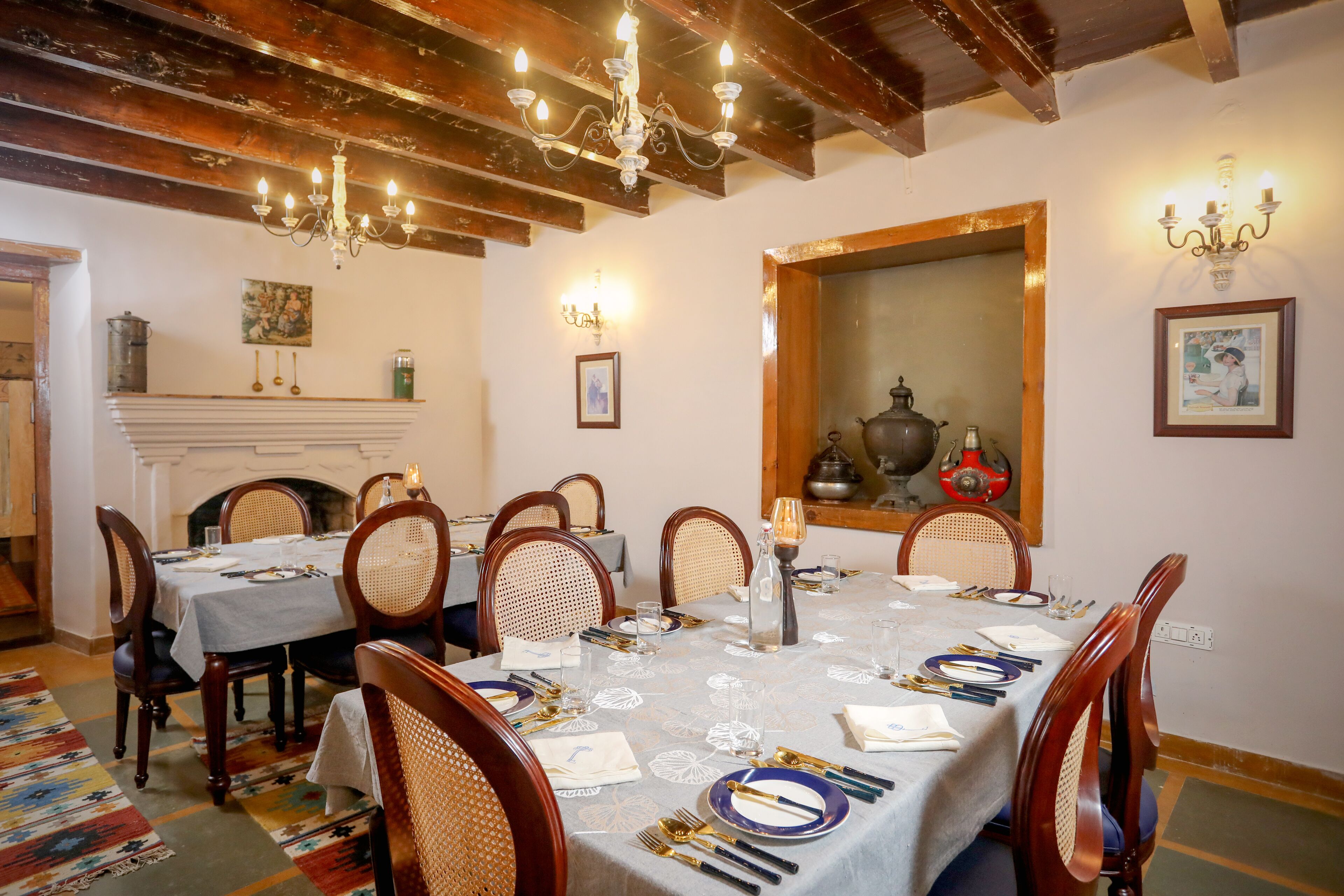 A dining room with a large table set for six, surrounded by wooden chairs.
