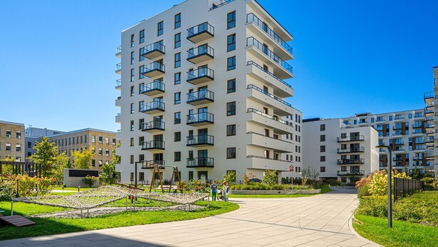 A modern multi-story residential building with balconies, a paved walkway, and surrounding greenery. - Lotnisko Chopina Modern Studio (Warszawa)