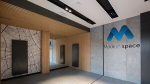 A modern interior with a map wall, a logo for 'Modern Space', and a clean, minimalist design. - Wiktoryn Comfortable Two-Room Apartment (Warszawa)