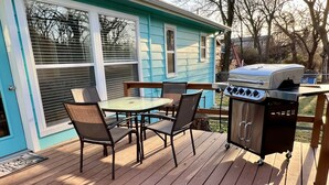 A deck with a grill and a table with chairs. - Home in Disney - Ride Directly to Trails, 1/2 mile to Marina & Boat Ramp (Disney)