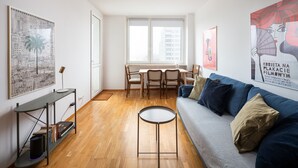 Una sala moderna con sofá, mesa de centro y comedor.