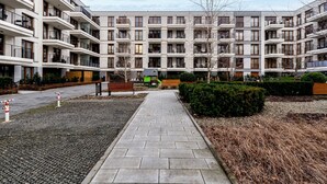 A modern apartment building with multiple balconies and a central courtyard. - Cracow Novum Apartment #58 (Kraków)