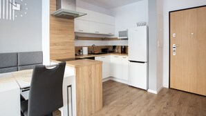 Eine moderne Küche mit weißen Schränken, einer Holz Arbeitsplatte und einem eingebauten Herd.