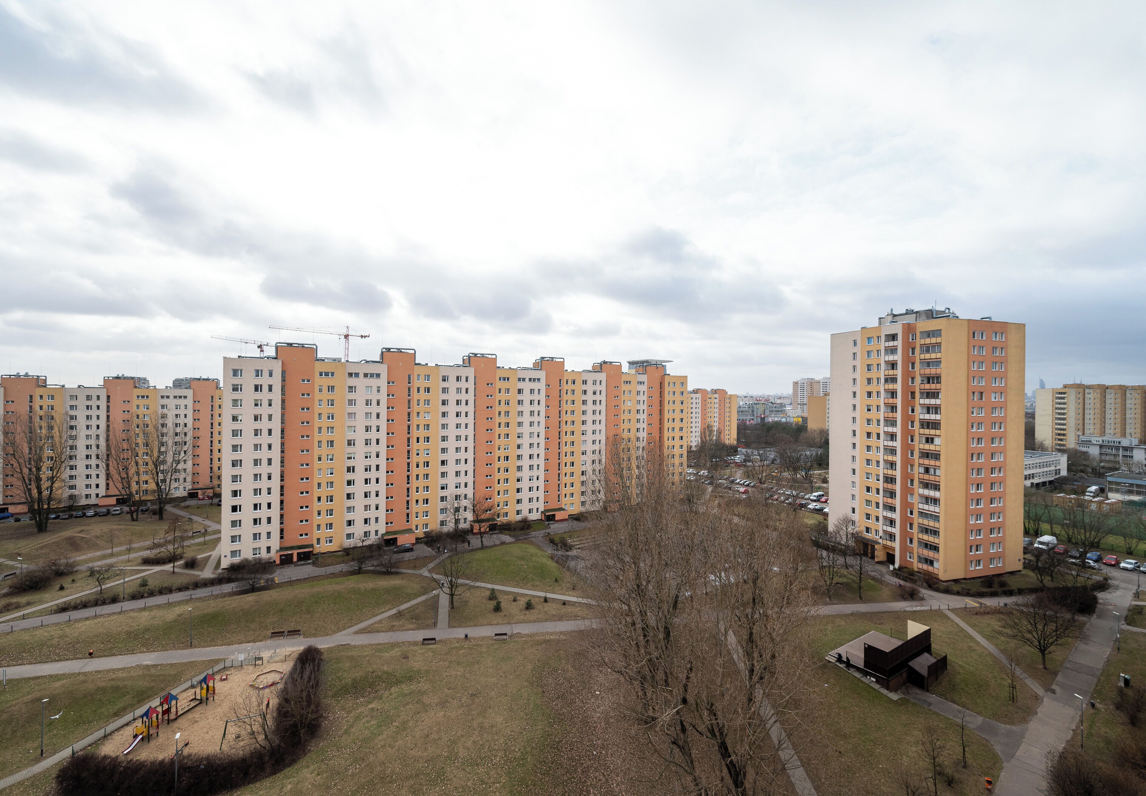 A residential area with apartment buildings, a playground, and a park.