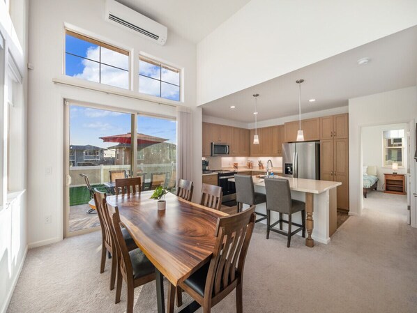 A modern kitchen with a central island, wooden cabinets, and stainless steel appliances. - Hot Tub|Mountain Views|Beach 6 Min|Gated|4 Parking (Waianae)
